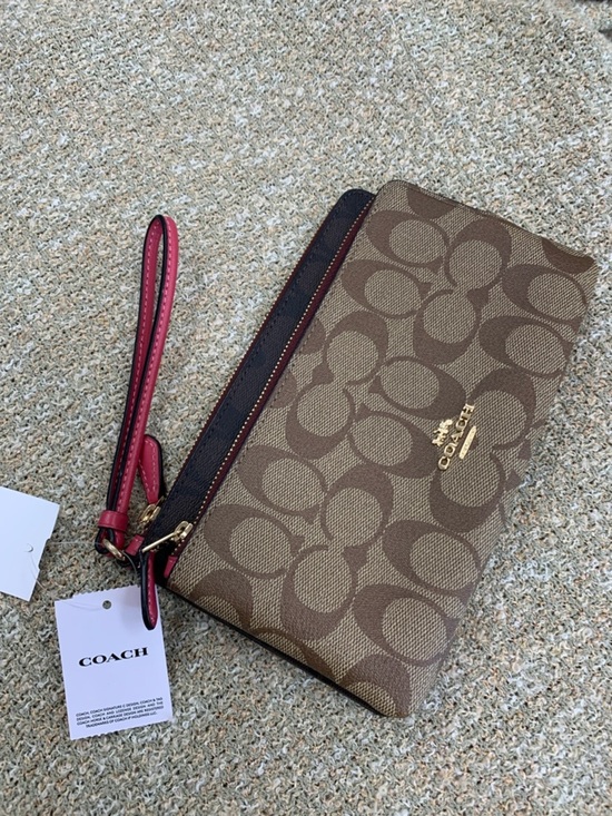 Coach Handbags - Coach Brown Signature Canvas Wristlet with Pink Strap